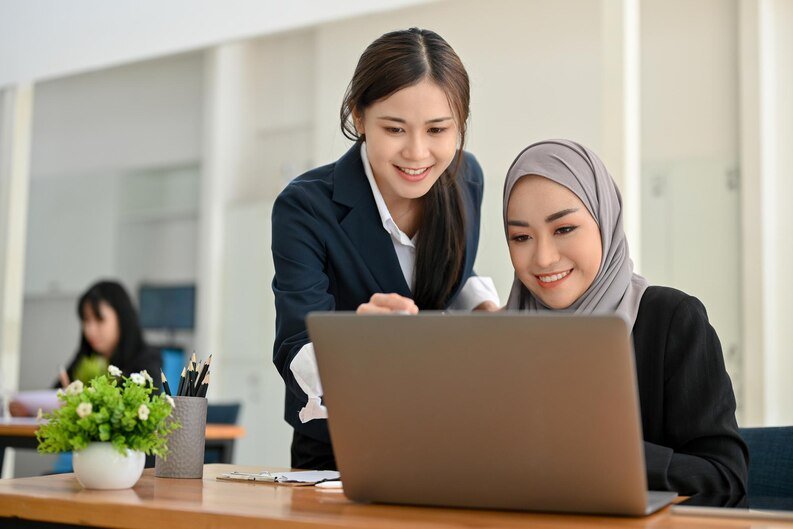fpdl.in_attractive-asian-businesswoman-training-giving-advice-her-muslim-colleague-office_67155-24243_medium