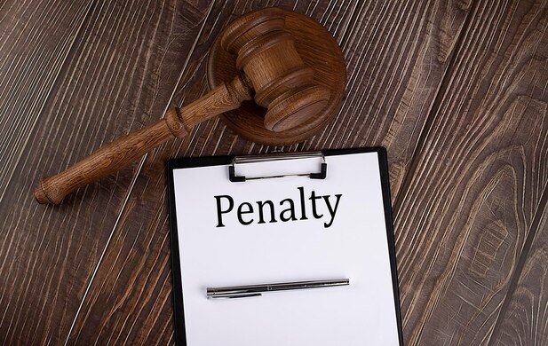 penalty-text-paper-with-gavel-wooden-background_376538-1522